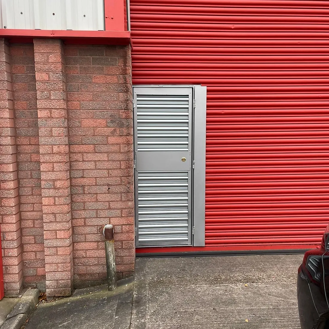 Before and after of a wicket gate being fitted into an existing roller shutter (Motor Garage in Dudley)